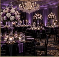 Upscale ballroom with purple lighting, chandeliers, and elegant floral centerpieces